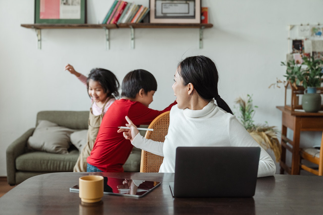 woman doing remote work looks away to check on kids